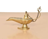 Brass genie lamp, angled view with chain and patterned top near the opening