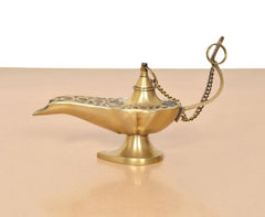 Brass genie lamp, angled view with chain and patterned top near the opening