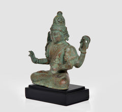 Bronze Lord Vishnu statue in profile, seated pose with four arms, on black base