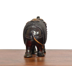Dark bronze elephant figurine, rear view, textured patterned back and tail
