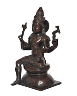 Lord Shiva statue from side angle, seated with trident weapons and ornate headgear, dark brass finish