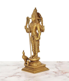 Brass standing Kartikeya idol, side profile with arched back and raised weapon