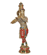 Brass Krishna flute idol sculpture, profile view, red trousers with multicolor beadwork