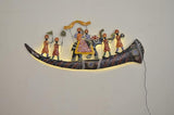 Iron wall showpiece with curved base, painted figures, and visible hanging wire