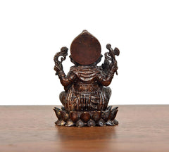 Lord Ganesha brass idol back view, large circular halo and lotus base