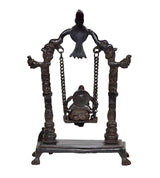Brass Ganesha swing idol statue from back view, with chained swing and pillar frame