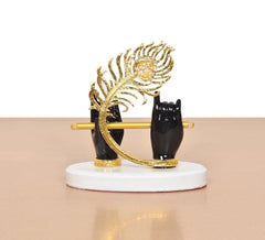 Black resin Krishna hands with flute, gold peacock hood, white circular base