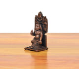 Copper guru idol figurine, seated figure on pedestal, side view with tall back support.