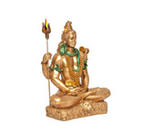 Seated Shiva murti holding trident and damaru, gold finish with green accents