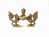 Brass Lord Ganesha lamp diya with peacock pair, sculpted figures and lit bowl