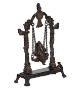 Brass Ganesha swing statue with seated deity on chained swing, four decorative pillars