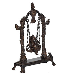 Brass Ganesha swing statue with seated deity on chained swing, four decorative pillars