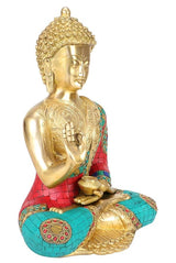 Brass Buddha statue from back angle, raised hand; teal and red mosaic leggings, gold details