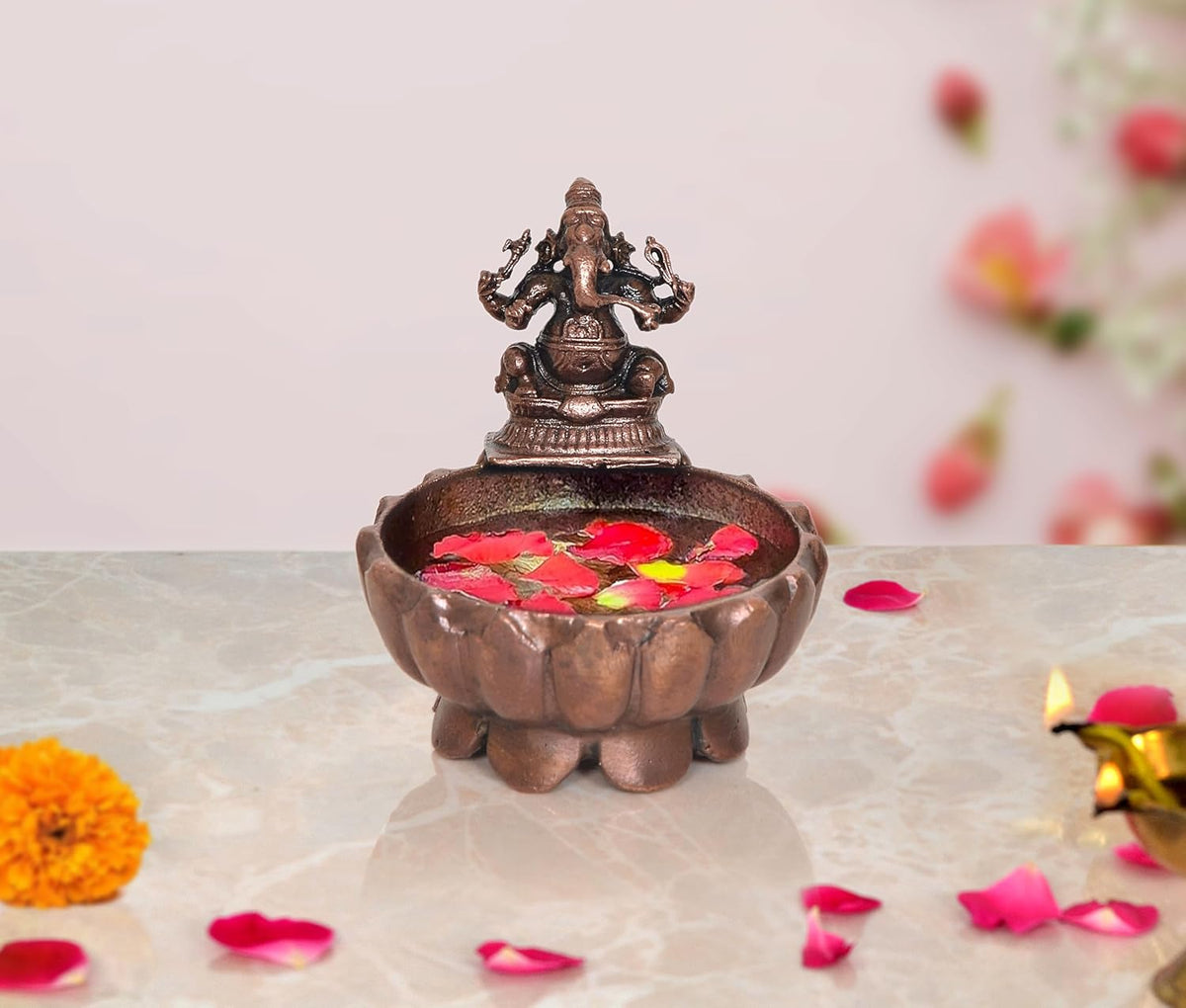 Copper Ganesha urli bowl with painted flowers in the basin