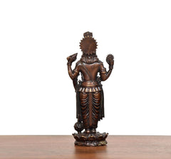 Brass Lord Vishnu idol back view, crown and flowing draped garment, raised arms