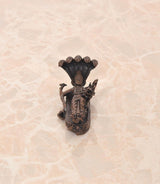 Back view of copper Vishnu-Lakshmi idol on Sheshnag serpent, seated deity figure