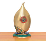 Brass Ganesha conch murti close-up of golden back with circular multicolor medallion