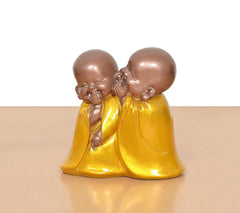Resin laughing Buddha monk sculpture, close view of two monks hugging in yellow robes