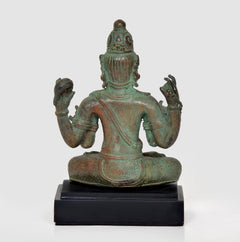 Back view of Lord Vishnu bronze statue, seated on black base with four-arm posture