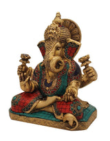 Brass Ganesha statue in seated posture, detailed face, twisted trunk, jeweled ornaments