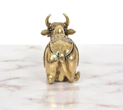 Bronze Nandi statue from rear, visible horns and flowing tail detail