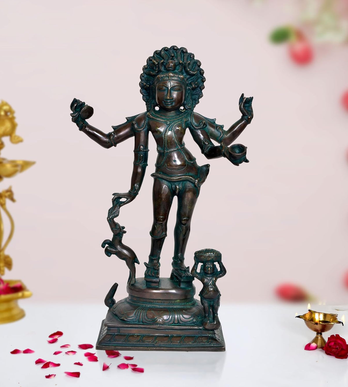 Shiva Bhikshatana sculpture with teal patina, raised arms, standing on carved pedestal