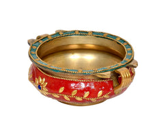 Brass urli with red enamel, gold leaf patterns, blue bead trim, and open gold bowl