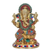 Brass Ganesha idol statue with colorful beadwork and patterned crown, seated on pedestal