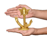 Ganesha idol statue held in hands for scale; gold-tone finish, round base