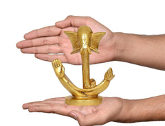 Ganesha idol statue held in hands for scale; gold-tone finish, round base