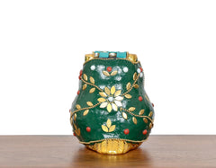 Metal owl statue back view with gold flower and leaf motifs on green body