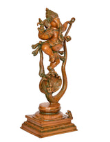 Brass Ganesha idol with green enamel detailing, dancing on Shesha serpent