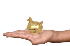 Brass peacock sindoor box in hand, compact size with engraved rim
