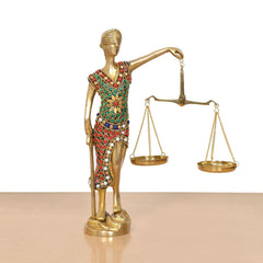Lady Justice brass figurine holding balance scales, colorful beadwork on dress