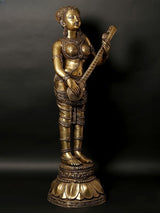 Brass standing Apsara sculpture holding veena, detailed jewelry and draped skirt