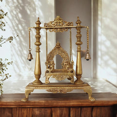 Brass jhula swing with carved frame and hanging bells, four legs