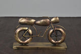Gold iron bike decorative statue with spoked wheels on rectangular base, front side