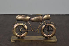 Gold iron bike decorative statue with spoked wheels on rectangular base, front side