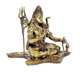Gold-tone Lord Shiva brass figure seated, side view with trident spear and ornaments