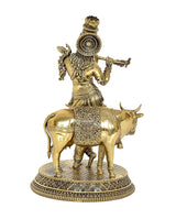 Brass Krishna on cow idol, opposite angle, engraved bodice, decorative round platform