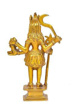 Golden brass Kali Maa statue from side view, trident in hand, ornate dress