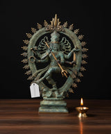 Bronze Nataraj Shiva dancing statue with multi arms and ornate halo, blue-green patina