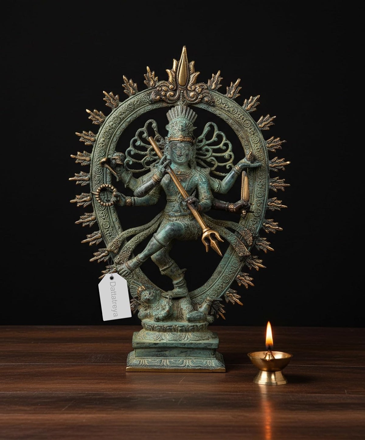 Bronze Nataraj Shiva dancing statue with multi arms and ornate halo, blue-green patina