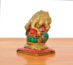 Side view of brass Panchmukhi Ganesha sitting murti with red, green, and gold