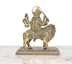 Durga Maa bronze idol on lion, rear three-quarter view with flowing drapery