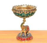 Brass elephant urli idol with green bowl base, jeweled trim and painted red outfit