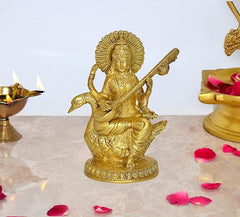 Brass Saraswati idol on swan murti, golden finish, round pedestal base