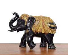 Black and gold elephant figurine, side view, detailed golden patterned chest & back