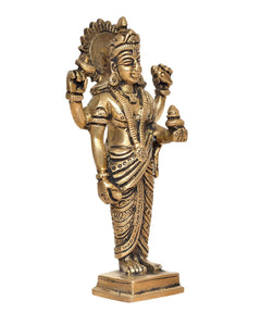 Brass Dhanvantri statue angled view, raised left hand and detailed headgear, pedestal base