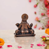 Copper Kuber idol statue, back view with Om-like emblem on headdress